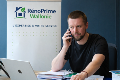 Conseiller RénoPrime Wallonie accompagnant un propriétaire pour le financement Rénopack à taux zéro en Wallonie